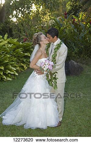 Wedding couple kissing; Hawaii, United States of America View Large Photo Image Stock Image - Wedding couple kissing; Hawaii, United States of America. Fotosearch