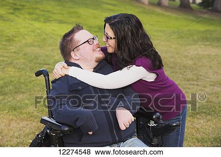Wife hugging disabled husband in a park in autumn; Edmonton, Alberta, Canada View Large Photo Image Stock Photo - Wife hugging disabled husband in a park in autumn; Edmonton, Alberta, Canada. Fotosearch