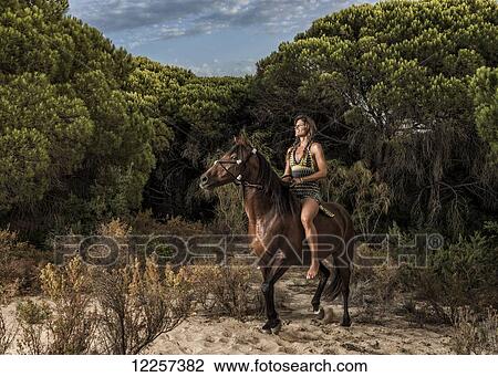 Woman horseback riding; Tarifa, Cadiz, Andalusia, Spain View Large Photo Image Stock Image - Woman horseback riding; Tarifa, Cadiz, Andalusia, Spain. Fotosearch