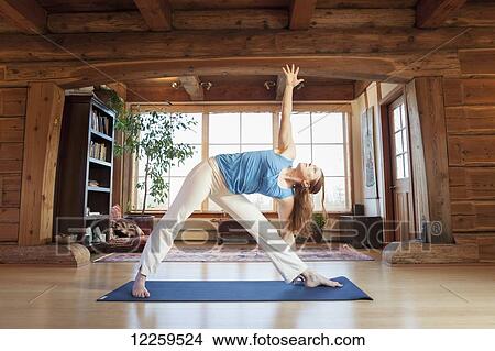 Picture - Woman practices yoga at indoor studio, Homer, Alaska. Fotosearch
