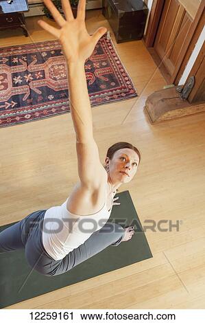 Stock Image - Woman practices yoga at indoor studio, Homer, Alaska. Fotosearch