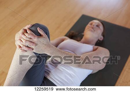 Woman practices yoga at indoor studio, Homer, Alaska View Large Photo Image Stock Photo - Woman practices yoga at indoor studio, Homer, Alaska. Fotosearch