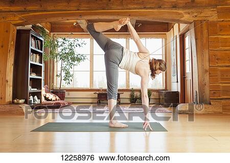Woman practices yoga positions at indoor studio, Homer, Alaska View Large Photo Image Stock Photograph - Woman practices yoga positions at indoor studio, Homer, Alaska. Fotosearch