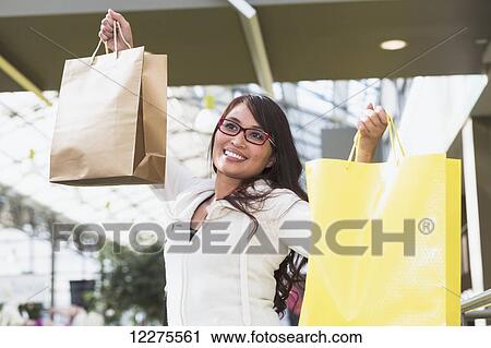 Woman shopping at a mall; St. Albert, Alberta, Canada View Large Photo Image Stock Image - Woman shopping at a mall; St. Albert, Alberta, Canada. Fotosearch