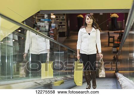 Stock Photo - Woman shopping at a mall; St. Albert, Alberta, Canada. Fotosearch