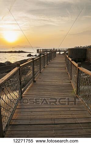 Wooden boardwalk with railing along the water; Xiamen, Fujian, China View Large Photo Image Stock Photography - Wooden boardwalk with railing along the water; Xiamen, Fujian, China. Fotosearch