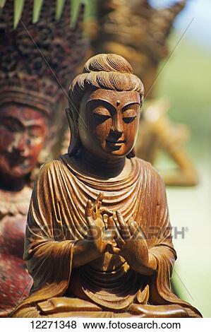 Stock Photo - Wooden carvings from Myanamar and Vietnam; Maui, Hawaii, United States of America. Fotosearch