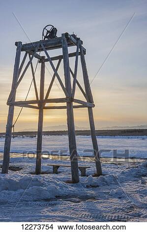 Picture - Wooden church bell tower during sunset in winter; Noatak, Alaska, United States of America. Fotosearch