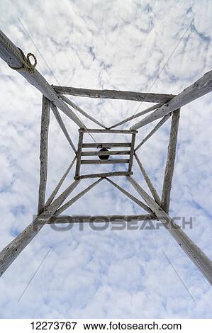 Stock Photo - Wooden church bell tower viewed from below with a cloudy sky; Noatak, Alaska, United States of America. Fotosearch