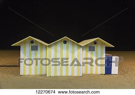 Yellow and white striped structures on the beach; Benidorm, Spain View Large Photo Image Picture - Yellow and white striped structures on the beach; Benidorm, Spain. Fotosearch