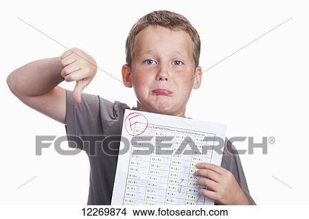 Young boy very disappointed in an F mark on his school math assignment; Alberta, Canada View Large Photo Image Picture - Young boy very disappointed in an F mark on his school math assignment; Alberta, Canada. Fotosearch