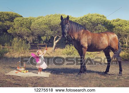 Young girl with pink ferry wings and a brown horse; Tarifa, Cadiz, Andalusia, Spain View Large Photo Image Stock Photo - Young girl with pink ferry wings and a brown horse; Tarifa, Cadiz, Andalusia, Spain. Fotosearch