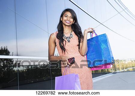 Young professional businesswoman with shopping bags in downtown setting; Edmonton, Alberta, Canada View Large Photo Image Stock Image - Young professional businesswoman with shopping bags in downtown setting; Edmonton, Alberta, Canada. Fotosearch