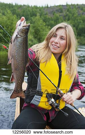 Young woman holding a large brook trout; Ontario, Canada View Large Photo Image Stock Image - Young woman holding a large brook trout; Ontario, Canada. Fotosearch