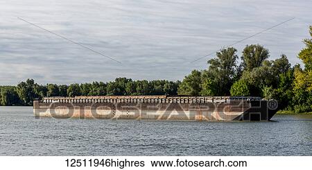 Stock Photograph - A barge traveling down the Danube River; Serbia. Fotosearch