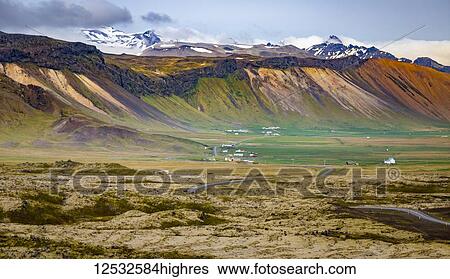 Stock Photograph - A beautiful long view across the colourful landscape of a valley from a tourist lookout; Iceland. Fotosearch