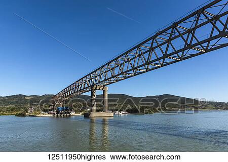 A bridge crossing over the Danube River with blue sky; Judetul Caras-Severin, Serbia View Large Photo Image Stock Photograph - A bridge crossing over the Danube River with blue sky; Judetul Caras-Severin, Serbia. Fotosearch