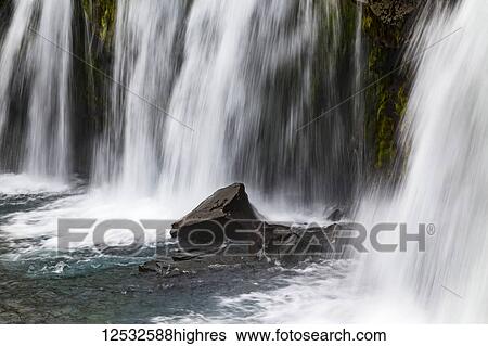 Stock Photograph - A close-up of Kirkjufellsfoss by the Kirkjufell mountain in Western Iceland; Grundarfjorour, Iceland. Fotosearch