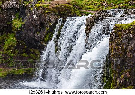 A close-up of Kirkjufellsfoss waterfall by the Kirkjufell mountain in Western Iceland; Grundarfjorour, Iceland View Large Photo Image Stock Photograph - A close-up of Kirkjufellsfoss waterfall by the Kirkjufell mountain in Western Iceland; Grundarfjorour, Iceland. Fotosearch