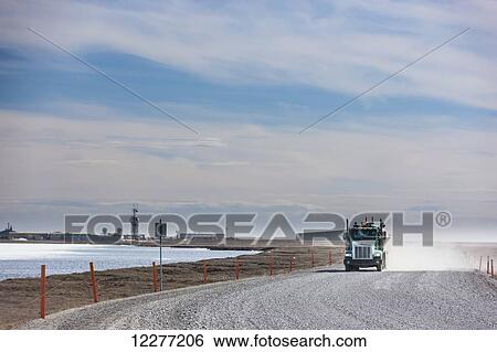 A commercial truck drives down a gravel tundra road on the North Slope, Prudhoe Bay, Arctic Alaska, USA, Summer View Large Photo Image Stock Photograph - A commercial truck drives down a gravel tundra road on the North Slope, Prudhoe Bay, Arctic Alaska, USA, Summer. Fotosearch