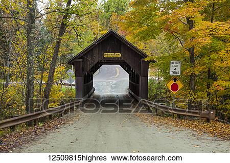 Stock Photograph - A covered bridge on a back country road in autumn, Green Mountains; Stowe, Vermont, United States of America. Fotosearch