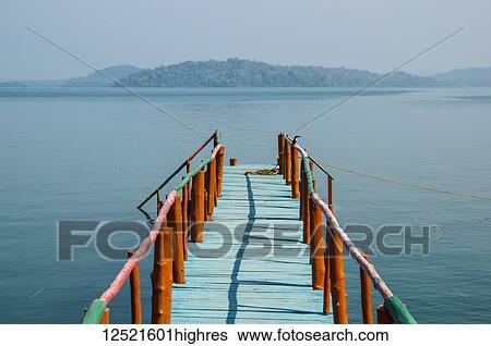 Stock Photograph - A dock leading out to the tranquil waters in the Bay of Bengal; Andaman Islands, India. Fotosearch