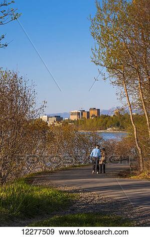 A elderly man and woman walk on the Tony Knowels Coastal Trail near downtown in Anchorage, Alaska, Spring View Large Photo Image Stock Photo - A elderly man and woman walk on the Tony Knowels Coastal Trail near downtown in Anchorage, Alaska, Spring. Fotosearch