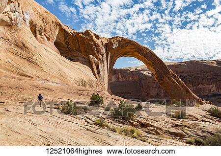 A female hiker approaching Corona Arch; Moab, Utah, United States of America View Large Photo Image Stock Photograph - A female hiker approaching Corona Arch; Moab, Utah, United States of America. Fotosearch