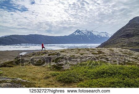 A female hiker walks along the edge of a hill on the trail above a glacier lake and mountain viewpoint in Southern Iceland, Vatnajokull National Park; Iceland View Large Photo Image Stock Photograph - A female hiker walks along the edge of a hill on the trail above a glacier lake and mountain viewpoint in Southern Iceland, Vatnajokull National Park; Iceland. Fotosearch
