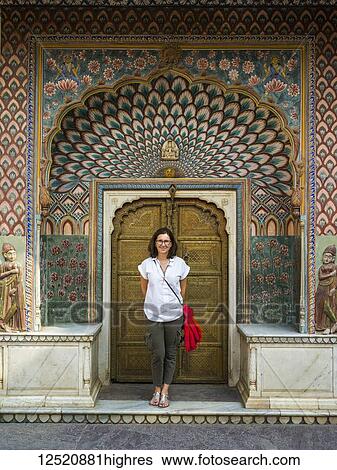 A female tourist stands in front of the Peacock Gate, City Palace; Jaipur, Rajasthan, India View Large Photo Image Stock Photograph - A female tourist stands in front of the Peacock Gate, City Palace; Jaipur, Rajasthan, India. Fotosearch
