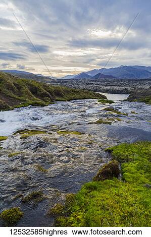 Stock Photograph - A gorgeous fresh water river runs through a valley in Western Iceland; Iceland. Fotosearch