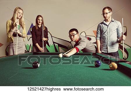 A group of young millennial business professionals playing a game of pool together on a work break; Sherwood Park, Alberta, Canada View Large Photo Image Stock Photograph - A group of young millennial business professionals playing a game of pool together on a work break; Sherwood Park, Alberta, Canada. Fotosearch
