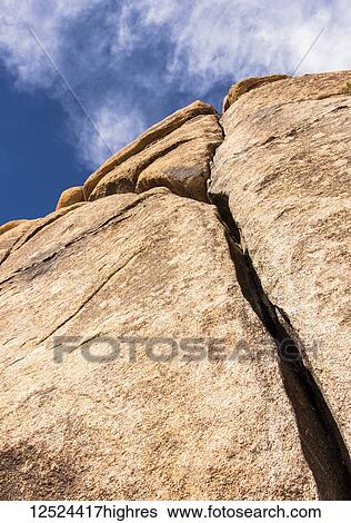 Stock Photograph - A large cracked boulder, Joshua Tree National Park; California, United States of America. Fotosearch