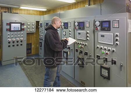 A male Hispanic worker inspects the control panels of an electrical power plant, Prudhoe Bay, Arctic Alaska, USA, Summer View Large Photo Image Picture - A male Hispanic worker inspects the control panels of an electrical power plant, Prudhoe Bay, Arctic Alaska, USA, Summer. Fotosearch