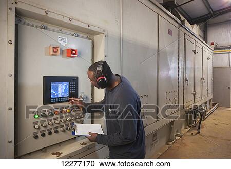 A Male laborer wearing ear protection inspects an electrical power plant control panel, Prudhoe Bay, Arctic Alaska, USA, Summer View Large Photo Image Stock Image - A Male laborer wearing ear protection inspects an electrical power plant control panel, Prudhoe Bay, Arctic Alaska, USA, Summer. Fotosearch