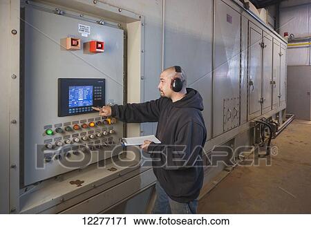 A Male laborer wearing ear protection inspects an electrical power plant control panel, Prudhoe Bay, Arctic Alaska, USA, Summer View Large Photo Image Stock Image - A Male laborer wearing ear protection inspects an electrical power plant control panel, Prudhoe Bay, Arctic Alaska, USA, Summer. Fotosearch