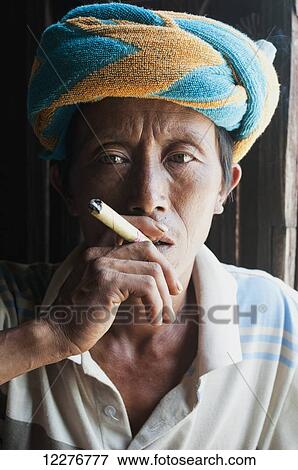 A man smoking a cigar; Myanmar View Large Photo Image Stock Photo - A man smoking a cigar; Myanmar. Fotosearch