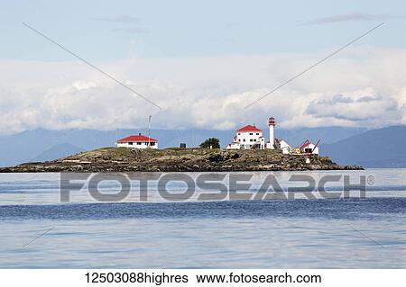 A manned lighthouse station on Entrance Island, near Nanaimo in the Georgia Straight, guides ferry traffic towards the harbour; Nanaimo, British Columbia, Canada View Large Photo Image Stock Photograph - A manned lighthouse station on Entrance Island, near Nanaimo in the Georgia Straight, guides ferry traffic towards the harbour; Nanaimo, British Columbia, Canada. Fotosearch