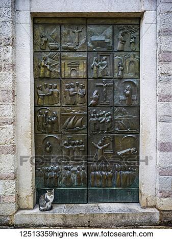 A metal door with pictograms placed in squares over the surface, and a cat sitting on the step; Monte View Large Photo Image Stock Photograph - A metal door with pictograms placed in squares over the surface, and a cat sitting on the step; Monte. Fotosearch