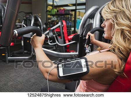 A middle-aged woman doing an upper body workout at a fitness facility; Spruce Grove, Alberta, Canada View Large Photo Image Stock Photograph - A middle-aged woman doing an upper body workout at a fitness facility; Spruce Grove, Alberta, Canada. Fotosearch