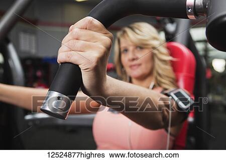 A middle-aged woman doing an upper body workout at a fitness facility; Spruce Grove, Alberta, Canada View Large Photo Image Stock Photograph - A middle-aged woman doing an upper body workout at a fitness facility; Spruce Grove, Alberta, Canada. Fotosearch
