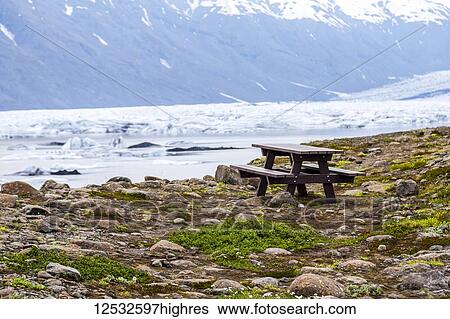 A picnic table sits on the edge of a viewpoint overlooking a glacier lake full of floating icebergs; Iceland View Large Photo Image Stock Photograph - A picnic table sits on the edge of a viewpoint overlooking a glacier lake full of floating icebergs; Iceland. Fotosearch