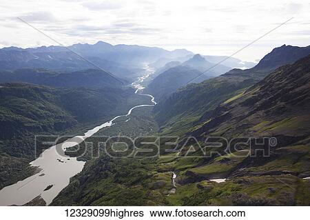 Stock Photograph - A river running through a valley in the Kenai Mountains, Kachemak Bay State Park; Alaska, United States of America. Fotosearch
