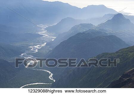 Stock Photograph - A river winding through a valley in the Kenai Mountains, Kachemak Bay State Park; Alaska, United States of America. Fotosearch