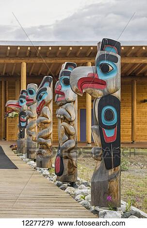A row of totem poles outside of a log lodge, Whitehorse, Yukon Territory, Canada, View Large Photo Image Stock Photo - A row of totem poles outside of a log lodge, Whitehorse, Yukon Territory, Canada, . Fotosearch
