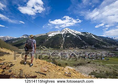 Stock Photograph - A senior man hiking with a view of Kendall Mountain in the distance; Silverton, Colorado, United States of America. Fotosearch