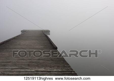 A small wooden dock with dense fog at the end over the water of Scott Lake in autumn; Olympia, Washington, United States of America View Large Photo Image Stock Photograph - A small wooden dock with dense fog at the end over the water of Scott Lake in autumn; Olympia, Washington, United States of America. Fotosearch