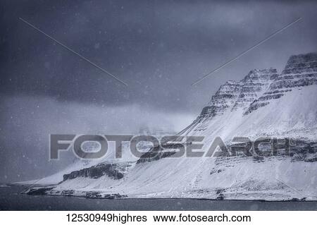 Stock Photograph - A snow storm along the Strandir Coast on Iceland's West Fjords; Iceland. Fotosearch