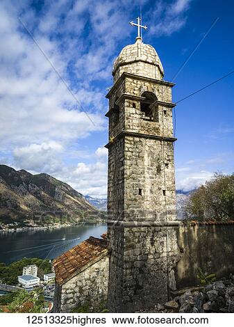 Stock Photograph - A stone tower with cross at Kotor Fortress and a view of the Gulf of Kotor; Kotor, Monte. Fotosearch