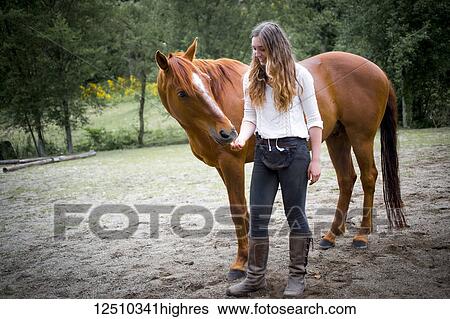A teenage girl to feed and care for her horse; British Columbia, Canada View Large Photo Image Stock Photograph - A teenage girl to feed and care for her horse; British Columbia, Canada. Fotosearch